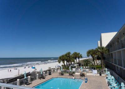 A pool deck and beach shot of the Beachside hotel Panama City Beach
